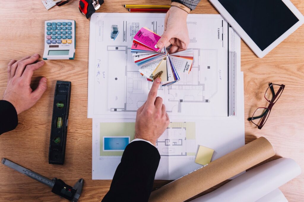 Hand Holding Architectural Plans for a New Building Design